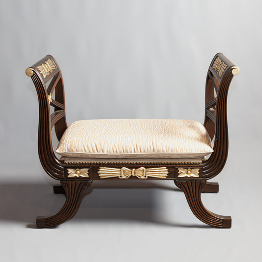 Empire-style wooden bench with gold accents.