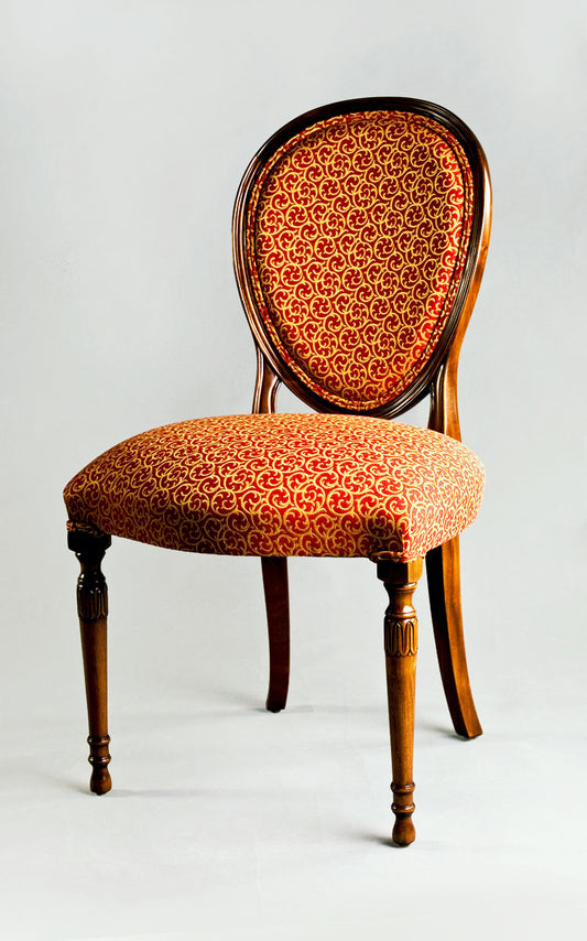 Hepplewhite side chair with intricate backrest carvings and cushioned seat.