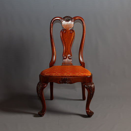 Sophisticated side chair with detailed carvings and comfortable seat.