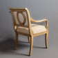 Classic wooden armchair with a carved frame and luxurious fabric upholstery.