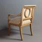 Side view of an armchair showcasing detailed craftsmanship and refined style.