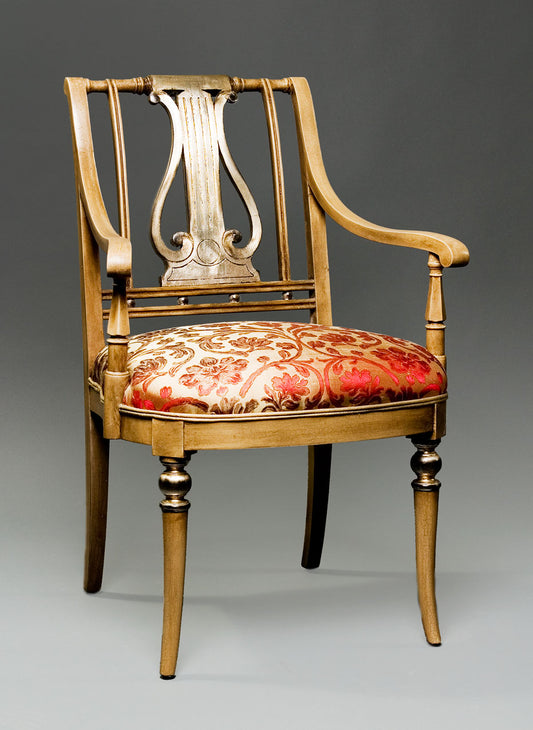 Sheraton-style music chair featuring a carved backrest and cushioned seat.