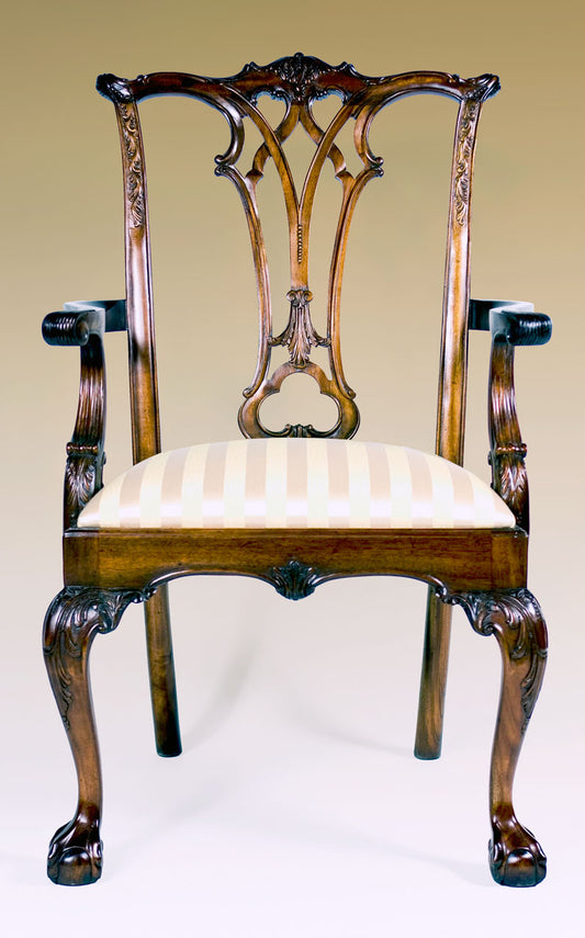New England Chippendale armchair with ornate carvings and plush seat.
