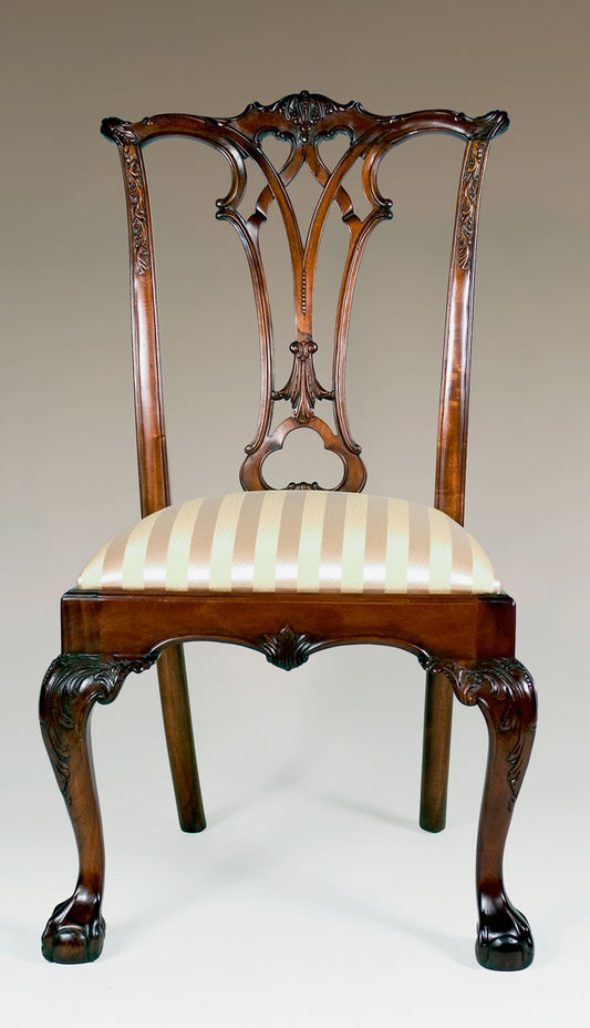 New England Chippendale side chair with refined woodwork and fabric seat.