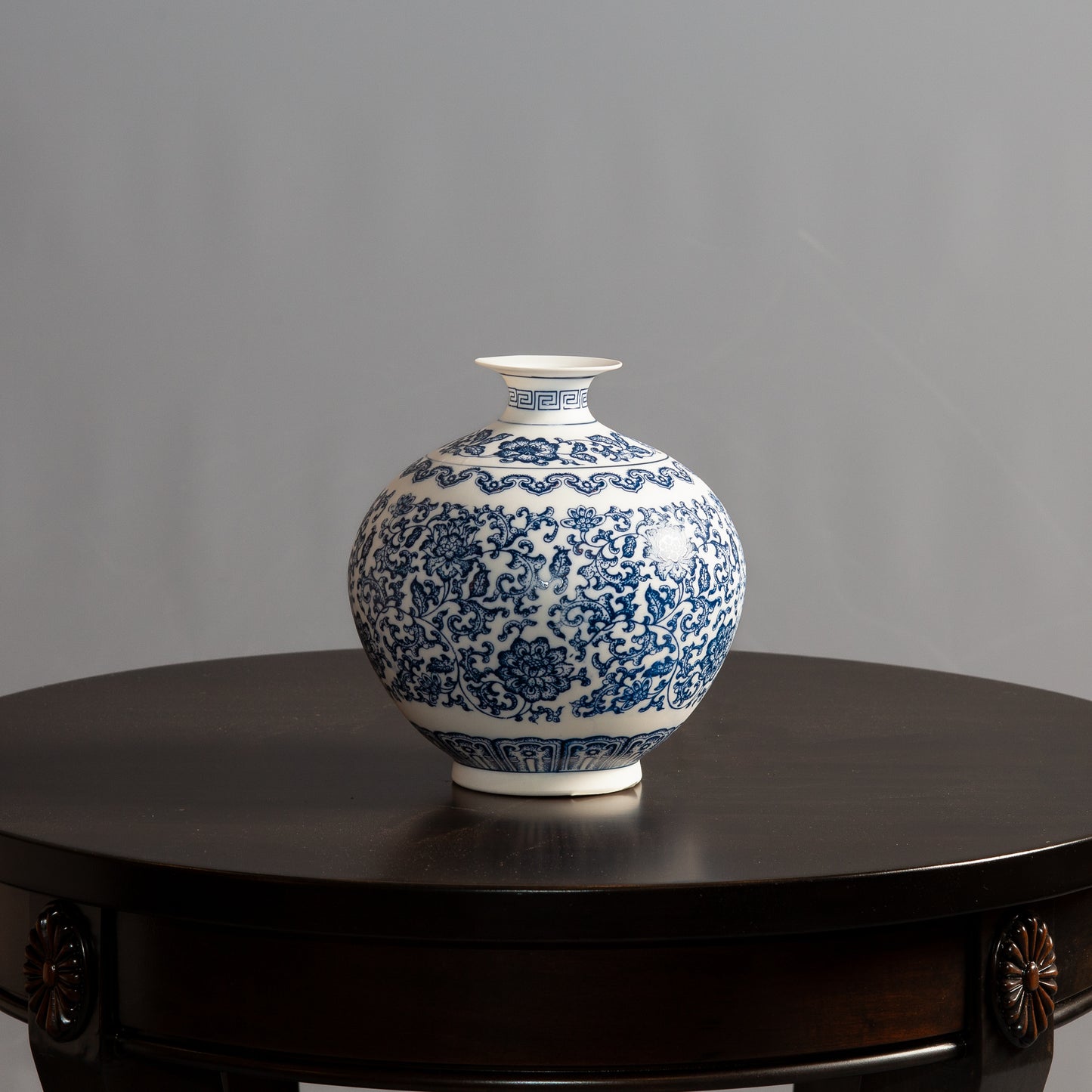 Wide blue and white ceramic vase with floral pattern