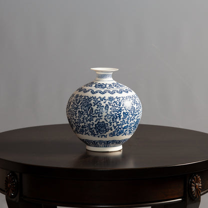 Wide blue and white ceramic vase with floral pattern